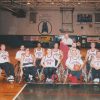 Basketball team of men in wheelchairs inside gymnasium