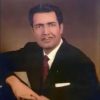 White man with pencil mustache posing in formal attire