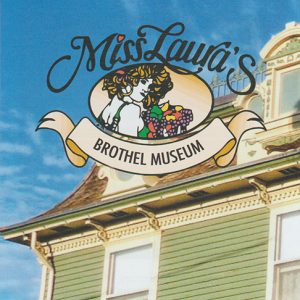 Brochure "Miss Laura's Brothel Museum" picturing a green building with an awning a a drawing of a woman