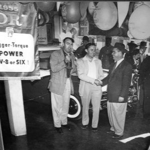 White men standing in front of a car