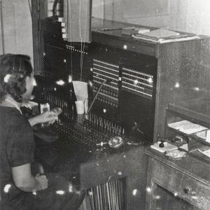 White woman in dress at telephone switchboard