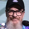 Bearded white man wearing cap and glasses