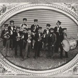 photo with a border of young white men mostly in black holding brass instruments and drums