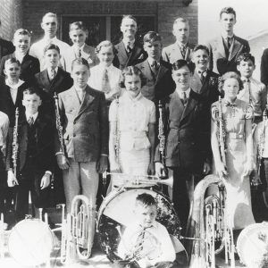 White older children and teens dressed up and holding instruments