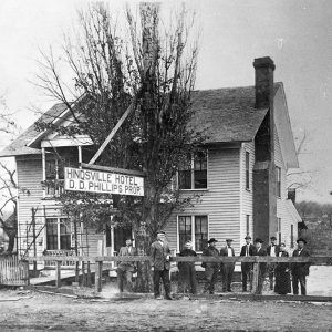 Multistory white wooden building with people standing in the foreground "Hindsville hotel D. D. Phillips Prop."