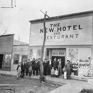 Group of white people standing before a restaurant building