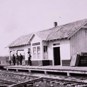 men standing on dock of a train station