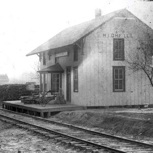 two story wooden railroad depot building with windows on front and side