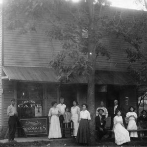 White men and women on the porch of a two-story restaurant building