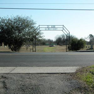 Fence and arched metal entrance to a cemetery "De Ann Cemetery"