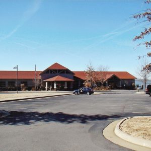 Single story wooden building with a red roof