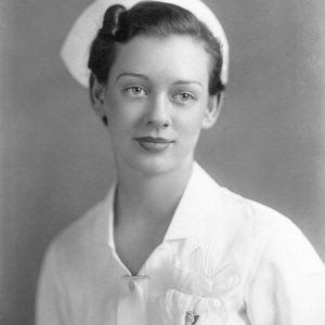 White woman dressed in white nurse uniform and hat