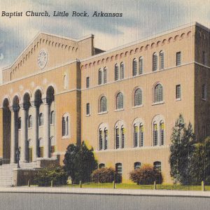 Large multistory brick and concrete building with four pillars and steps