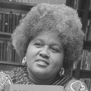 Black woman smiling looking off holding book titled "Down South"