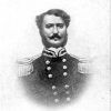 White man with handlebar mustache and muttonchops  wearing military uniform