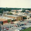 Elevated view of streetscape including various buildings parking lots streetlights and trees