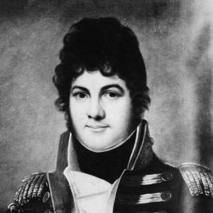 Young white man  from waist up dressed in military uniform large sideburns thick wavy short hairstyle