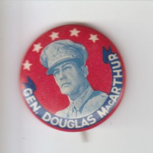 Round button with five star symbols above portrait of white man in military uniform above banner text "Gen. Douglas MacArthur"