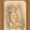 Aged portrait photograph white toddler sitting in rocking chair